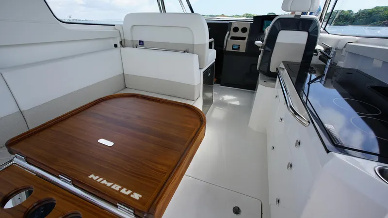 In-stock 2025 Nimbus W11 #60 Yacht Photos Pics Interior of 2025 Nimbus Weekender 11 #60, featuring sleek seating and wooden table.
