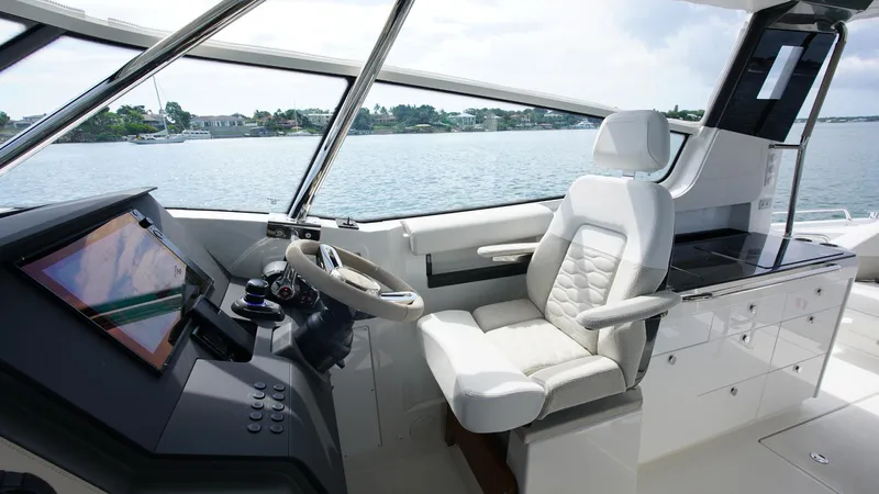 In-stock 2025 Nimbus W11 #60 Yacht Photos Pics Interior of 2025 Nimbus Weekender 11 #60 boat with modern helm and seating.