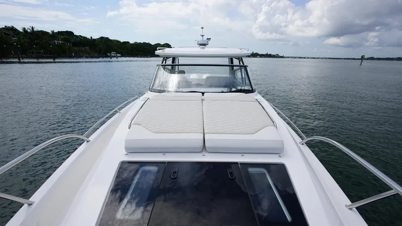 In-stock 2025 Nimbus W11 #60 Yacht Photos Pics 2025 Nimbus Weekender 11 #60 boat on calm water, featuring spacious deck and sleek design.