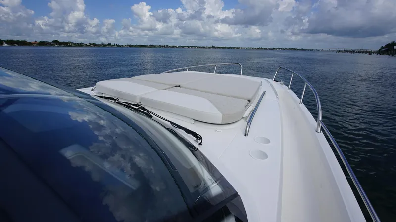 In-stock 2025 Nimbus W11 #60 Yacht Photos Pics Nimbus Weekender 11 #60 boat, 2025 model, cruising on a calm lake under a cloudy sky.