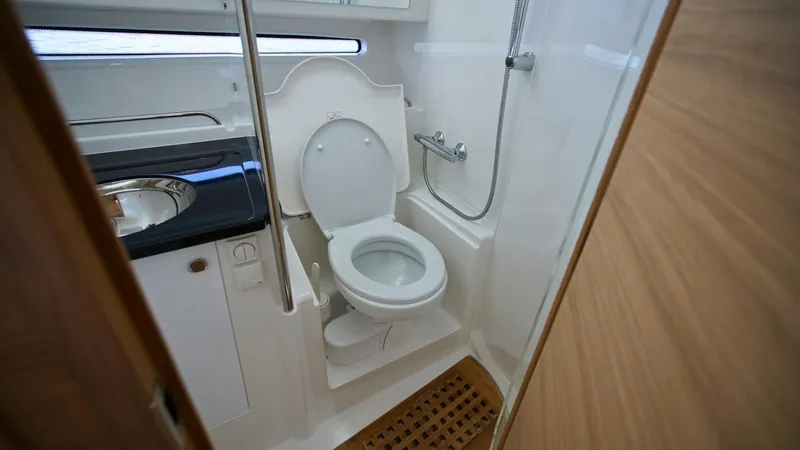 In-stock 2025 Nimbus W11 #60 Yacht Photos Pics Compact bathroom in 2025 Nimbus Weekender 11 #60 boat, featuring toilet and shower.