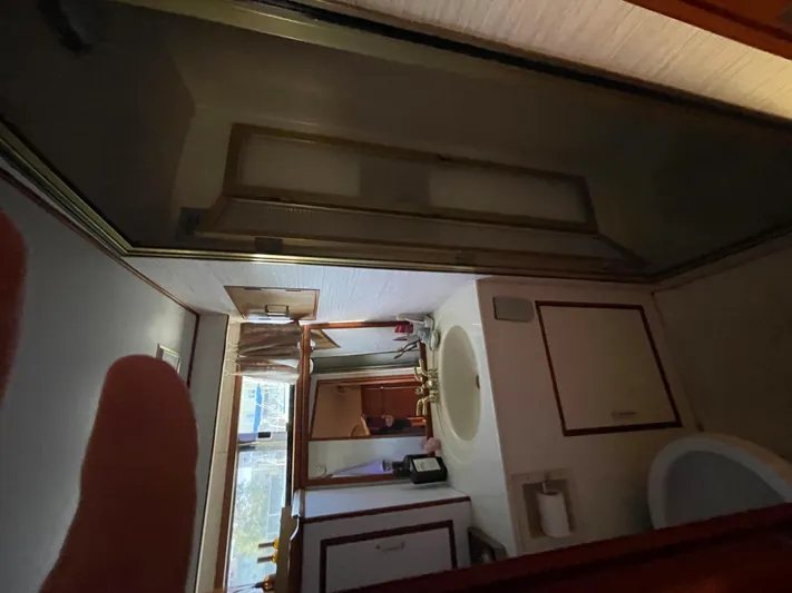  Yacht Photos Pics 1988 Marine Trader Aft Cabin bathroom with sink, mirror, and shower.