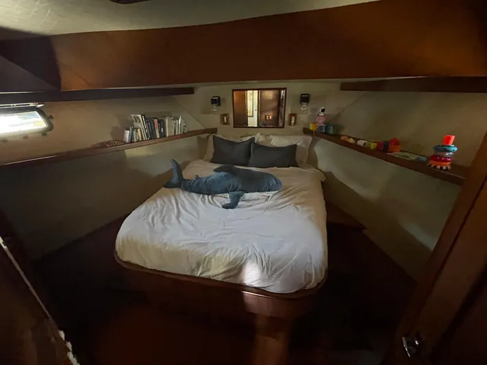 Yacht Photos Pics 1988 Marine Trader Aft Cabin bedroom with plush shark, books, and toys on shelves.