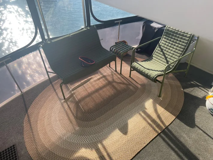  Yacht Photos Pics 1988 Marine Trader Aft Cabin interior with green chairs and oval rug.