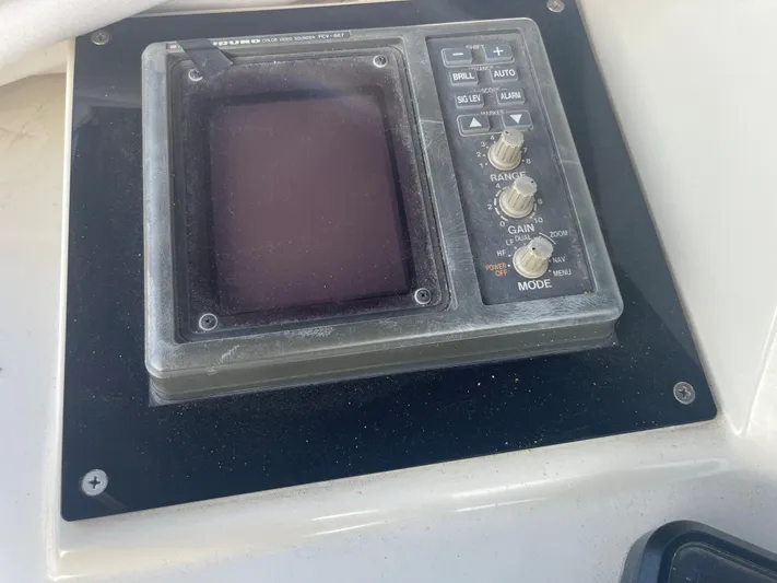  Yacht Photos Pics Control panel of a 1988 Marine Trader Aft Cabin boat, featuring various knobs and buttons.