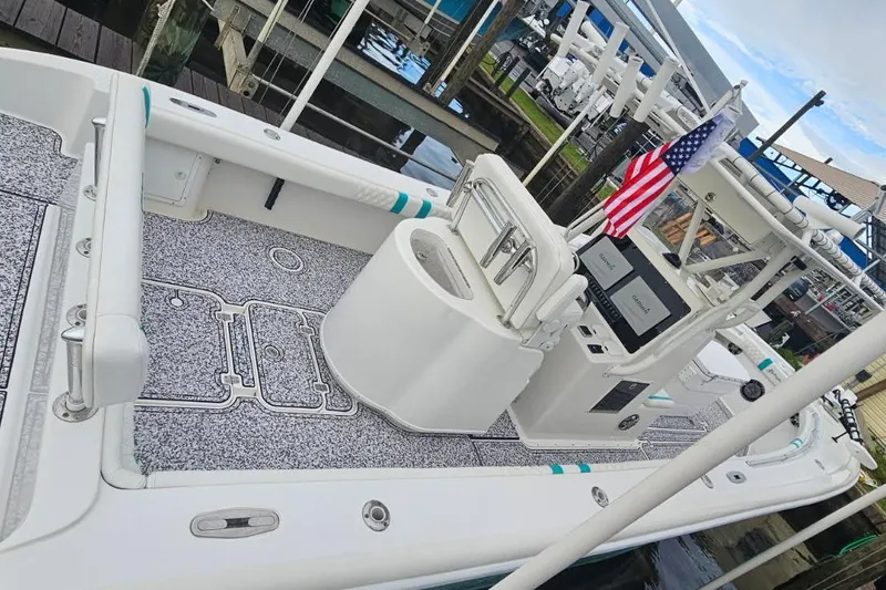  Yacht Photos Pics 2002 Yellowfin 31 Center Console boat docked, featuring spacious deck and American flag.