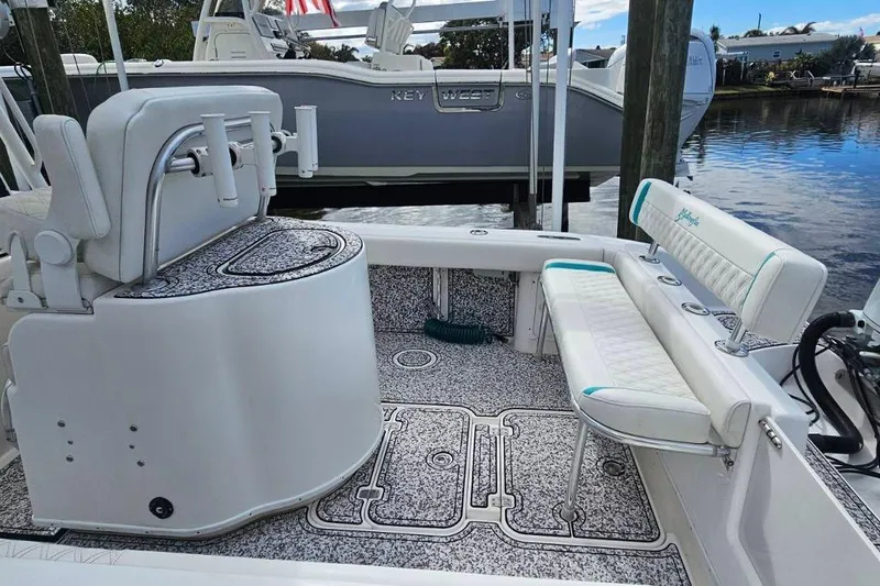  Yacht Photos Pics 2002 Yellowfin 31 Center Console boat interior with seating and storage, docked by the water.