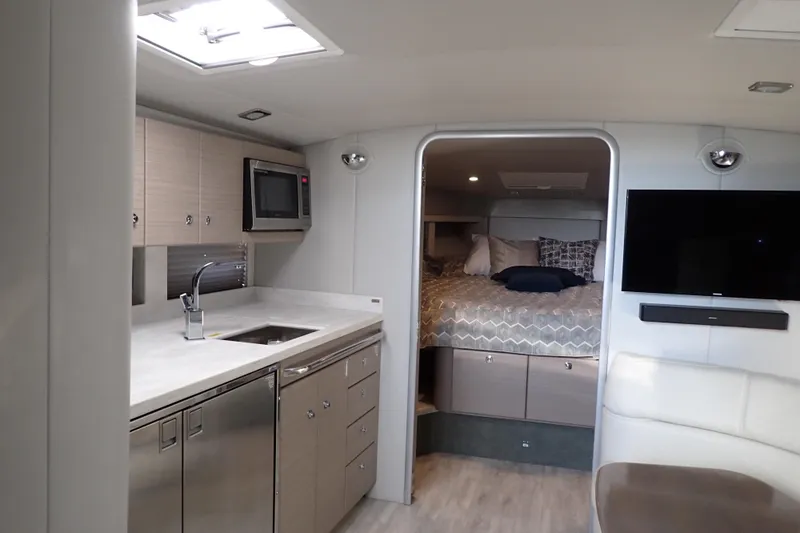  Yacht Photos Pics Interior of 2020 Formula 40 Performance Cruiser with modern kitchen and cozy sleeping area.
