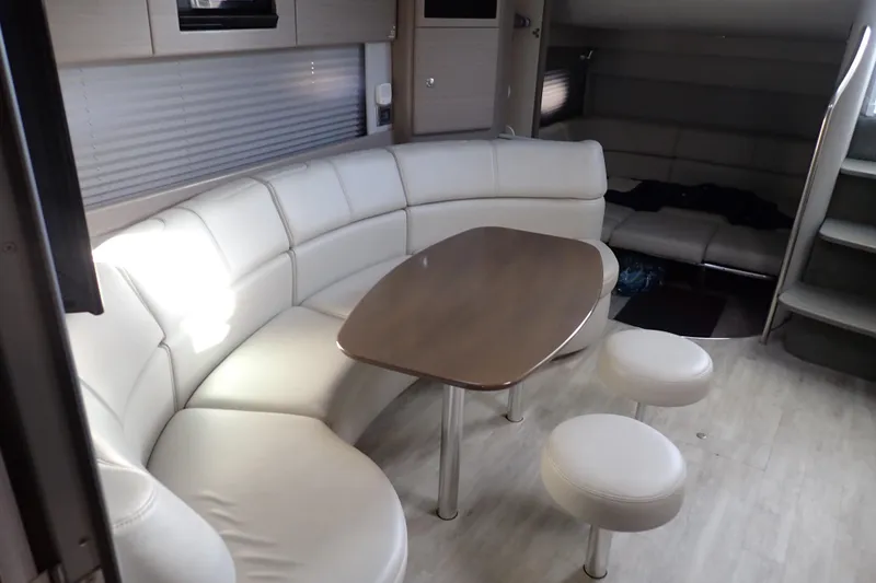  Yacht Photos Pics Interior of 2020 Formula 40 Performance Cruiser with white leather seating and wooden table.