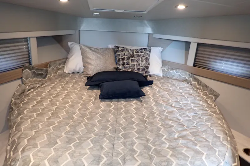  Yacht Photos Pics Cozy cabin interior of 2020 Formula 40 Performance Cruiser with patterned bedding and pillows.