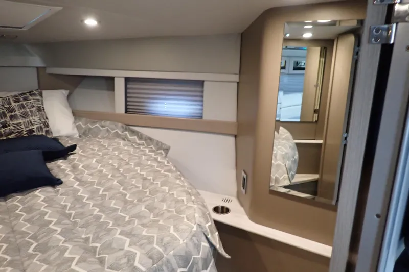  Yacht Photos Pics Cozy interior cabin of 2020 Formula 40 Performance Cruiser with bed and mirror.