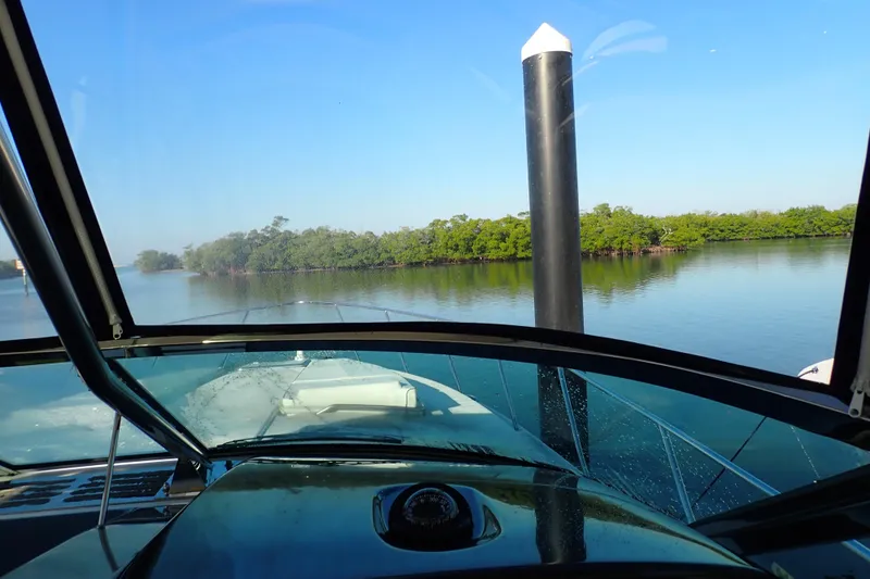  Yacht Photos Pics 2020 Formula 40 Performance Cruiser navigating calm waters with lush greenery.