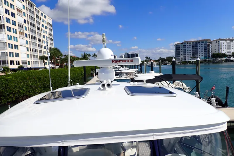  Yacht Photos Pics 2020 Formula 40 Performance Cruiser docked near waterfront buildings under blue sky.