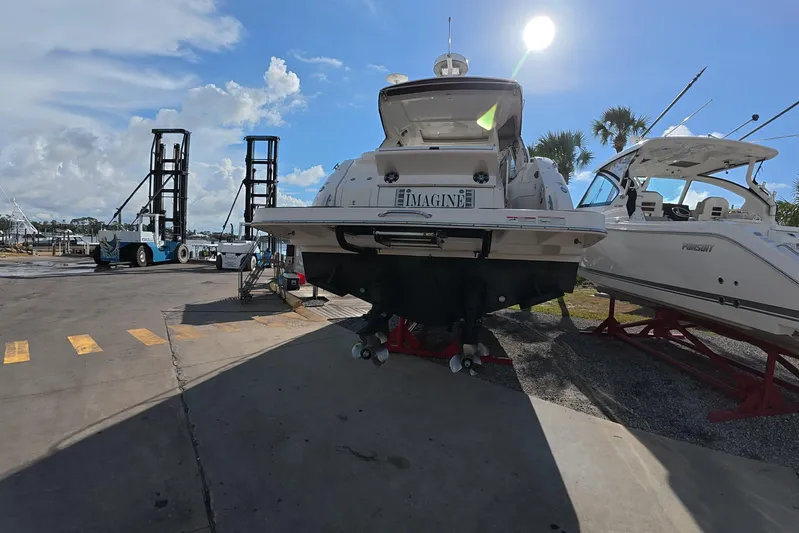  Yacht Photos Pics 2021 Sea Ray Sundancer 350 Coupe on dry dock under sunny skies.
