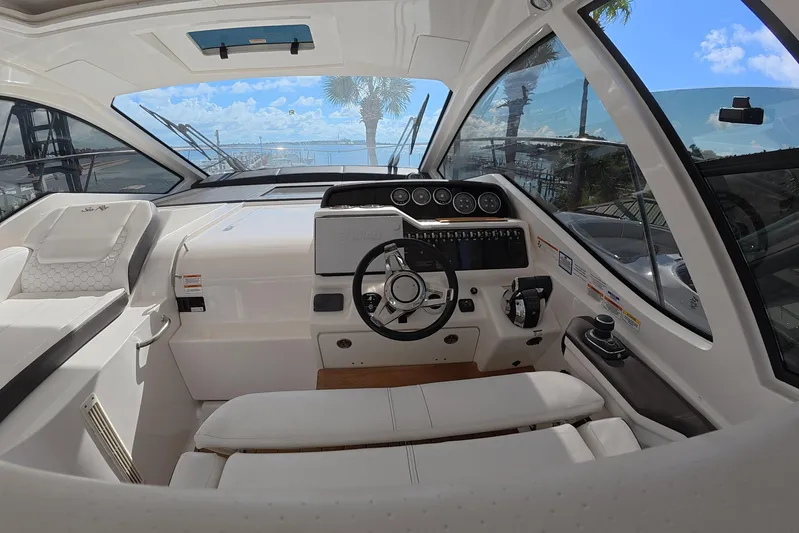  Yacht Photos Pics Interior cockpit of 2021 Sea Ray Sundancer 350 Coupe with steering wheel and dashboard.
