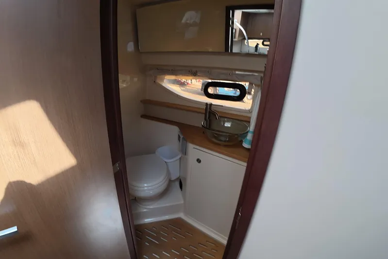  Yacht Photos Pics 2021 Sea Ray Sundancer 350 Coupe bathroom interior with modern fixtures and wooden accents.