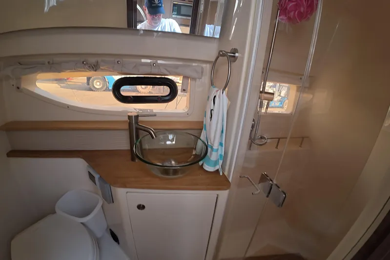  Yacht Photos Pics 2021 Sea Ray Sundancer 350 Coupe bathroom with glass sink and modern fixtures.