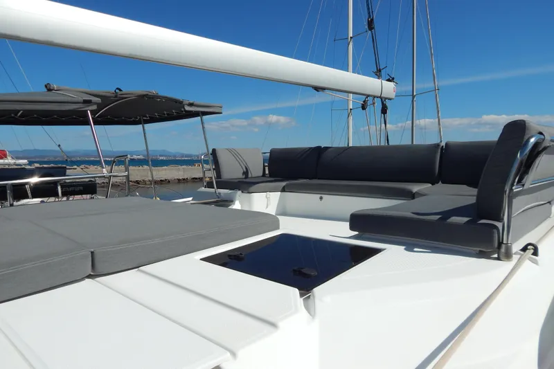  Yacht Photos Pics 2023 Fountaine Pajot Catamaran Elba 45 with spacious deck and seating area.