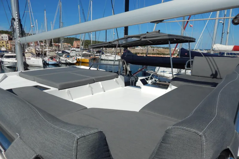  Yacht Photos Pics 2023 Fountaine Pajot Catamaran Elba 45 with spacious deck and seating in marina.