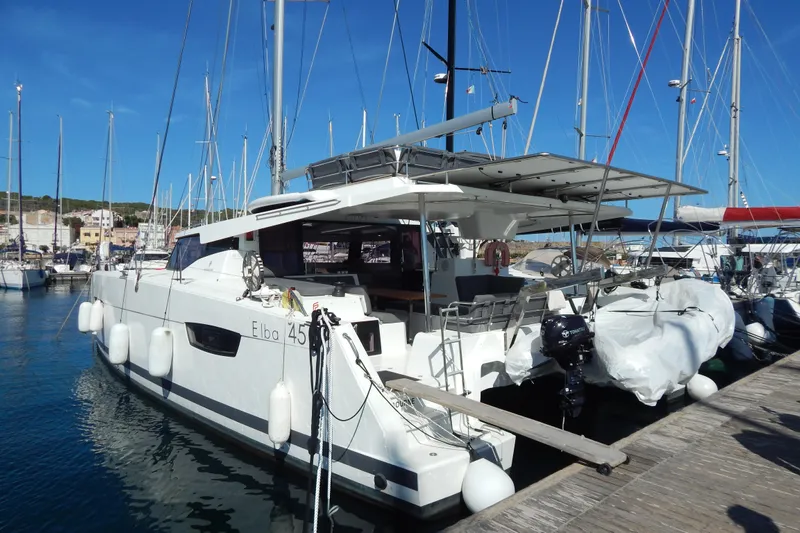  Yacht Photos Pics 2023 Fountaine Pajot Catamaran Elba 45 docked at marina under clear blue sky.