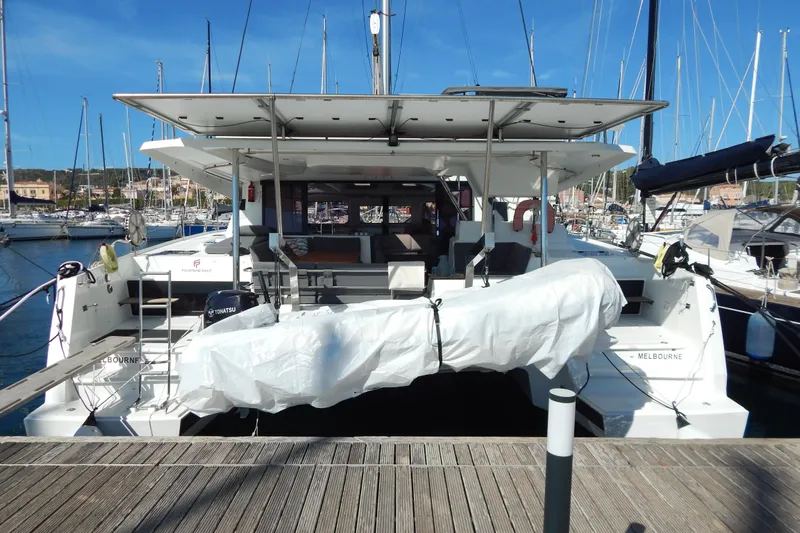  Yacht Photos Pics 2023 Fountaine Pajot Catamaran Elba 45 docked at marina, rear view.