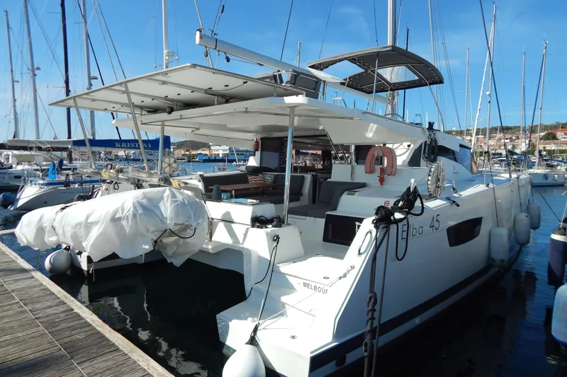  Yacht Photos Pics 2023 Fountaine Pajot Catamaran Elba 45 docked at marina, rear view.