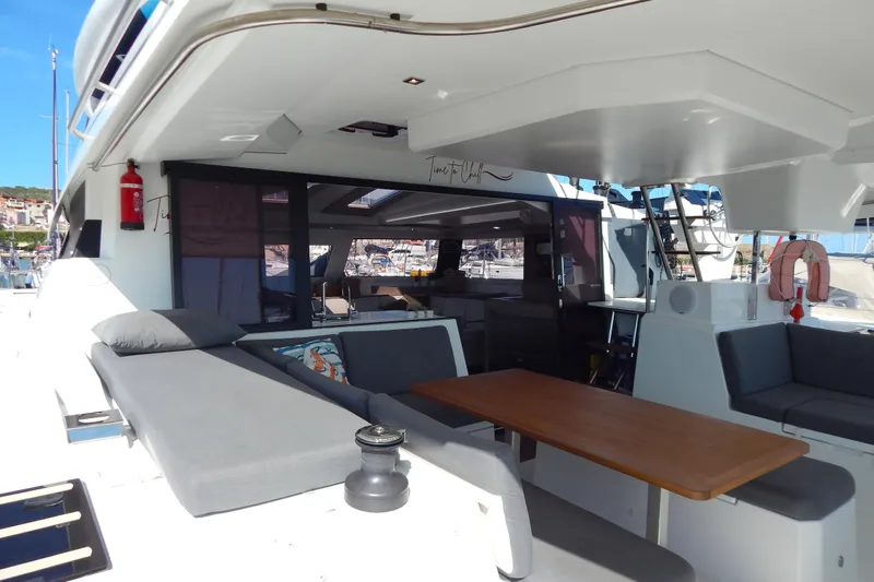  Yacht Photos Pics 2023 Fountaine Pajot Catamaran Elba 45 with spacious outdoor seating and dining area.