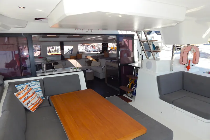  Yacht Photos Pics 2023 Fountaine Pajot Catamaran Elba 45 interior with modern seating and dining area.