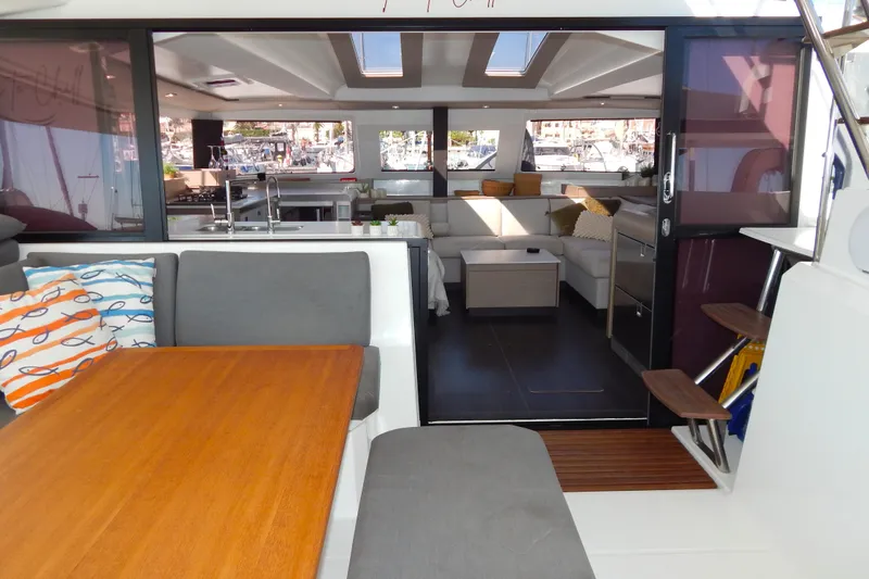  Yacht Photos Pics 2023 Fountaine Pajot Catamaran Elba 45 interior with modern seating and dining area.