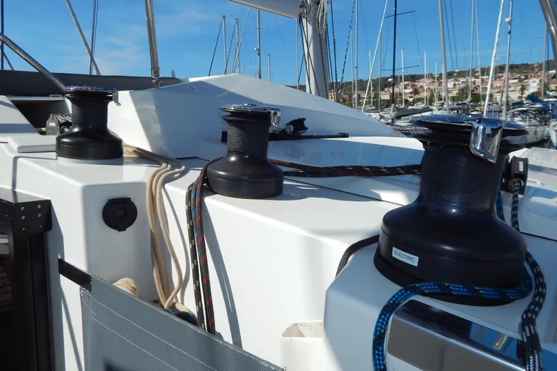  Yacht Photos Pics 2023 Fountaine Pajot Catamaran Elba 45 deck with winches and ropes in marina.