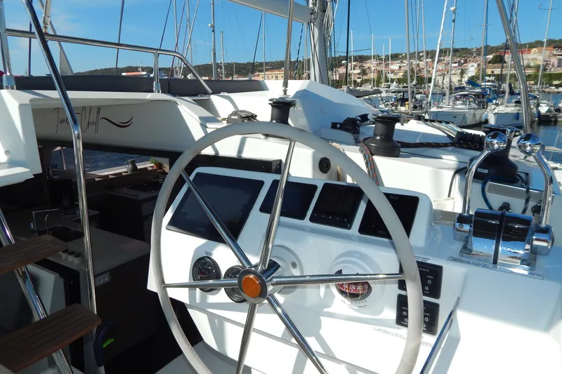 Yacht Photos Pics 2023 Fountaine Pajot Catamaran Elba 45 helm with modern navigation instruments in marina.