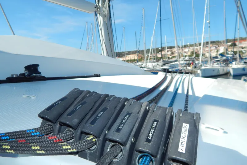  Yacht Photos Pics 2023 Fountaine Pajot Catamaran Elba 45 deck with rigging and marina view.