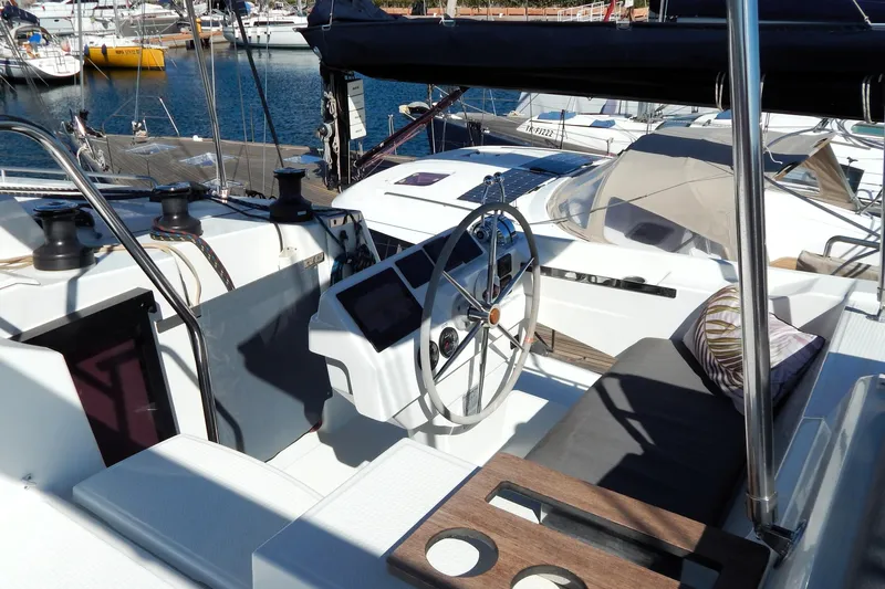  Yacht Photos Pics 2023 Fountaine Pajot Catamaran Elba 45 cockpit with steering wheel and marina view.