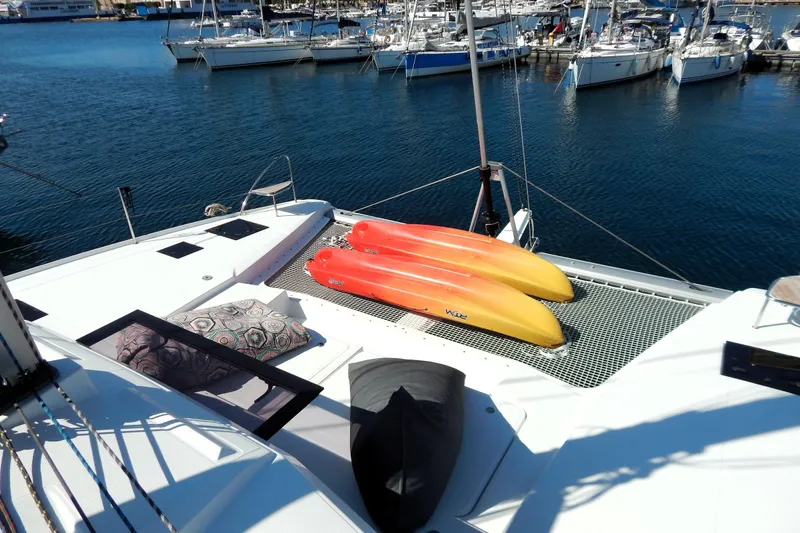  Yacht Photos Pics 2023 Fountaine Pajot Catamaran Elba 45 with kayaks on deck, docked at marina.
