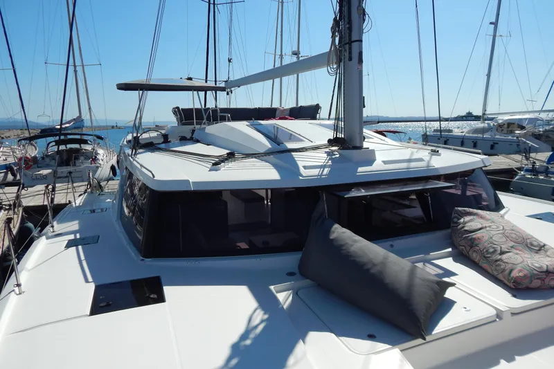  Yacht Photos Pics 2023 Fountaine Pajot Catamaran Elba 45 docked, featuring spacious deck and modern design.