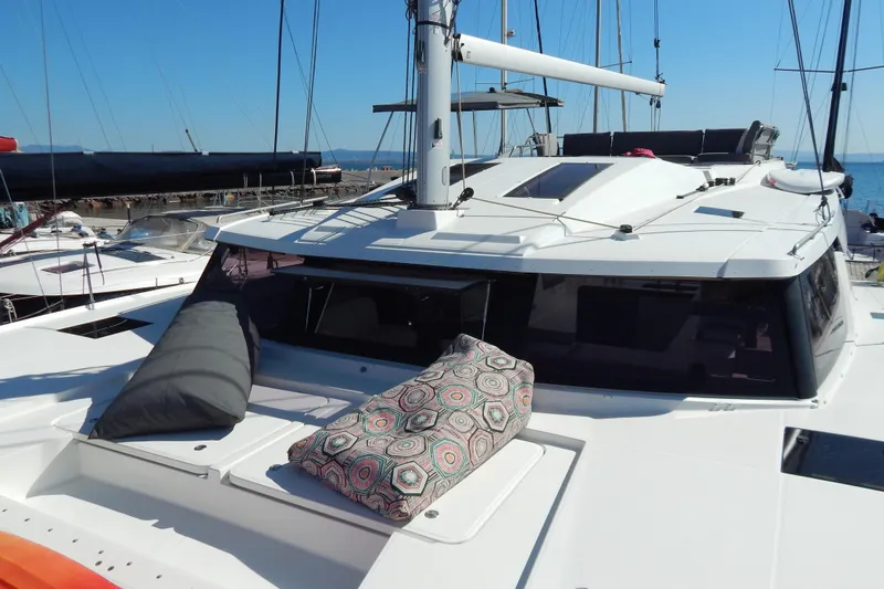  Yacht Photos Pics 2023 Fountaine Pajot Catamaran Elba 45 with cushions on deck, docked in marina.