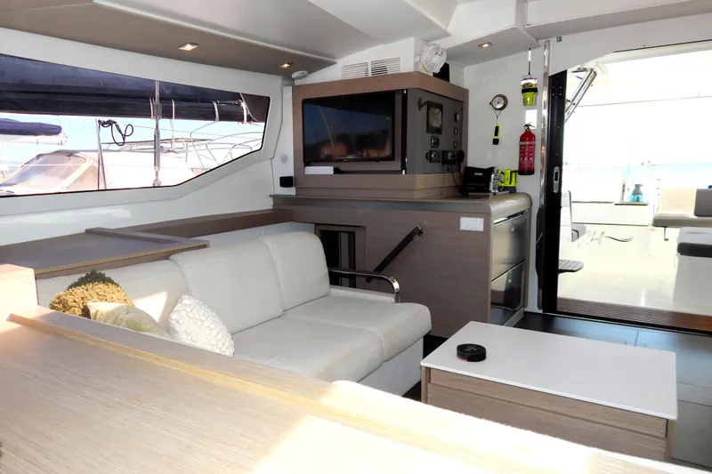  Yacht Photos Pics Interior of 2023 Fountaine Pajot Catamaran Elba 45 with modern furnishings and large windows.
