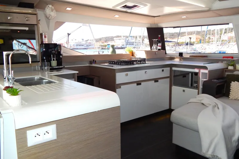  Yacht Photos Pics Modern kitchen interior of 2023 Fountaine Pajot Catamaran Elba 45, featuring sleek design and appliances.