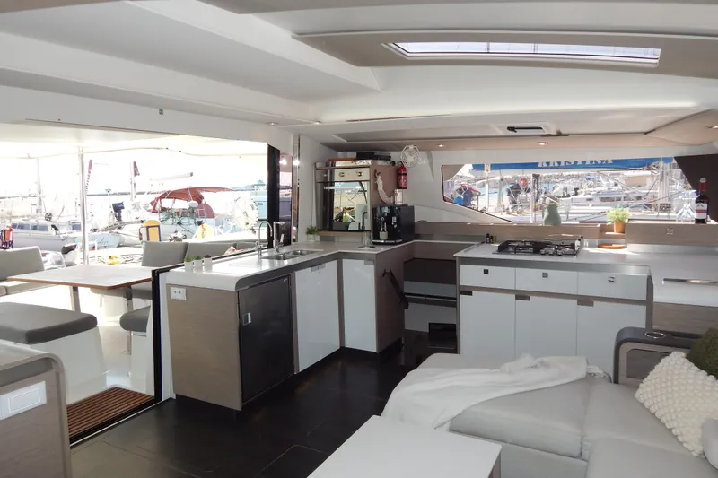  Yacht Photos Pics Interior of 2023 Fountaine Pajot Catamaran Elba 45 with modern kitchen and seating area.
