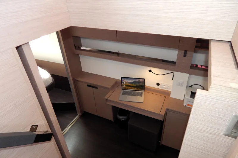  Yacht Photos Pics Modern interior of 2023 Fountaine Pajot Catamaran Elba 45 with workspace and laptop.