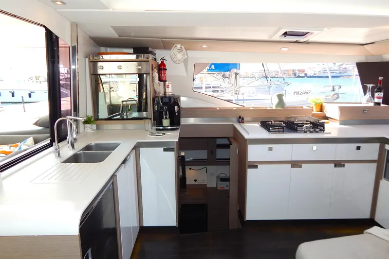  Yacht Photos Pics Modern kitchen interior of 2023 Fountaine Pajot Catamaran Elba 45 with sleek design and appliances.