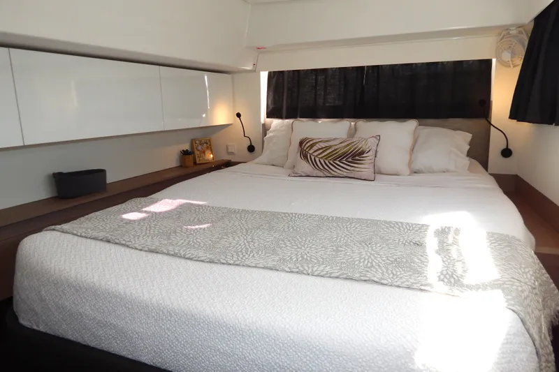  Yacht Photos Pics Luxurious bedroom interior of 2023 Fountaine Pajot Catamaran Elba 45 with elegant bedding.