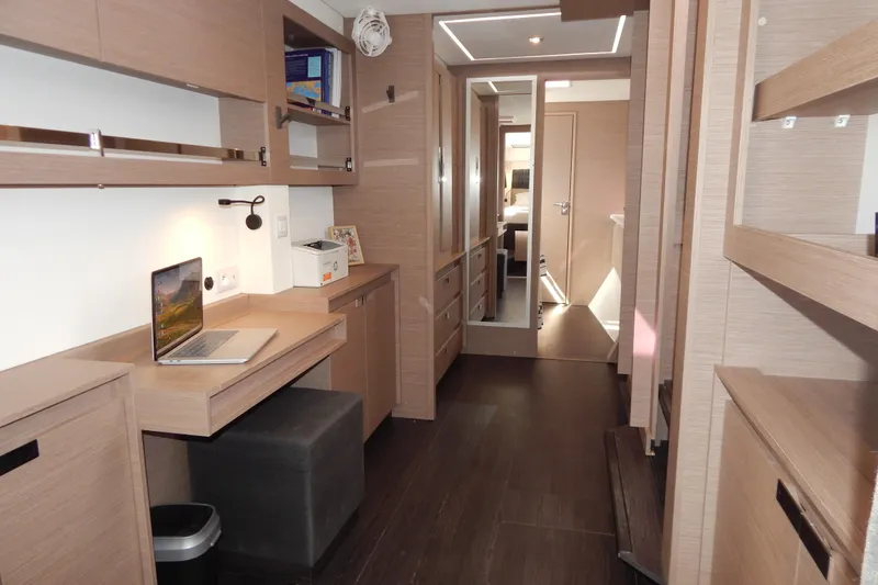  Yacht Photos Pics Modern interior of 2023 Fountaine Pajot Catamaran Elba 45 with workspace and storage.