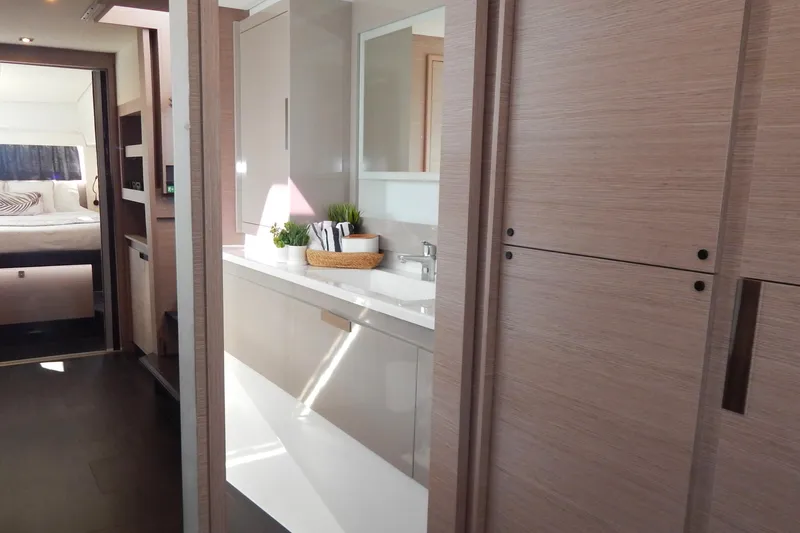  Yacht Photos Pics Luxurious interior of 2023 Fountaine Pajot Catamaran Elba 45, featuring modern design and cozy bedroom.