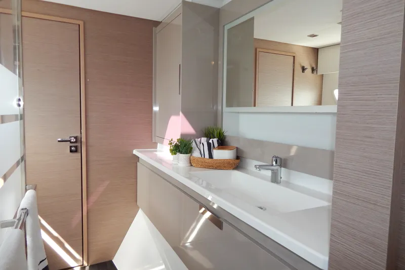  Yacht Photos Pics Modern bathroom interior of 2023 Fountaine Pajot Catamaran Elba 45, featuring sleek design elements.