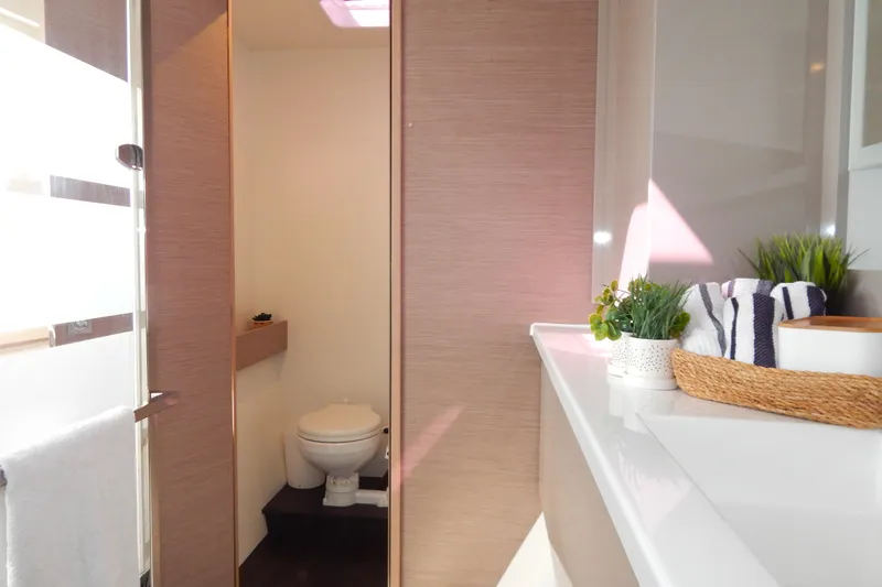  Yacht Photos Pics Modern bathroom interior on 2023 Fountaine Pajot Catamaran Elba 45, featuring sleek design elements.