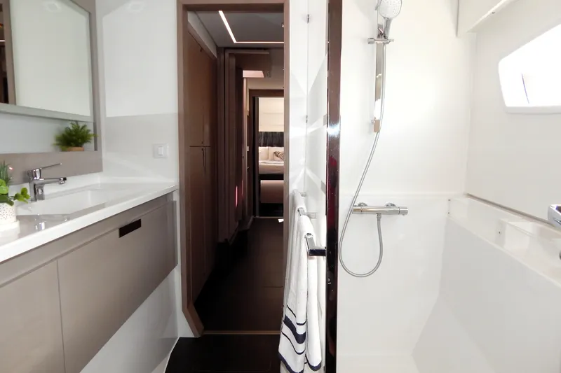  Yacht Photos Pics Modern bathroom interior of 2023 Fountaine Pajot Catamaran Elba 45, featuring sleek design and fixtures.
