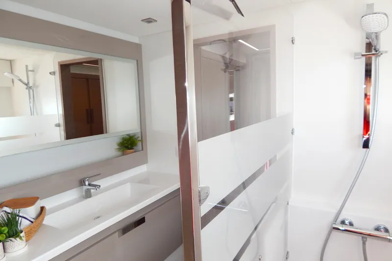  Yacht Photos Pics Modern bathroom in 2023 Fountaine Pajot Catamaran Elba 45, featuring sleek design and fixtures.