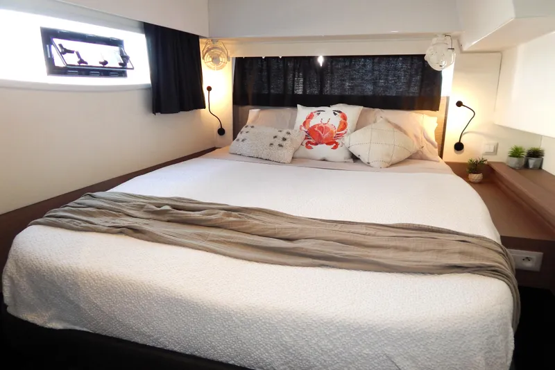  Yacht Photos Pics Luxurious bedroom interior of 2023 Fountaine Pajot Catamaran Elba 45 with cozy bedding.