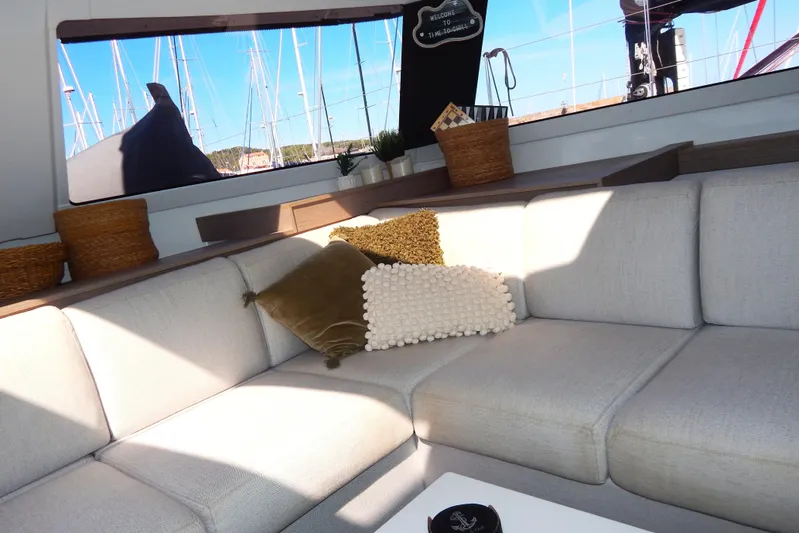  Yacht Photos Pics Interior of 2023 Fountaine Pajot Catamaran Elba 45 with cozy seating and decorative pillows.